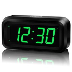 an alarm clock with green numbers on it