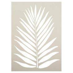 a white palm leaf is shown on a beige background with the shadow of it's leaves