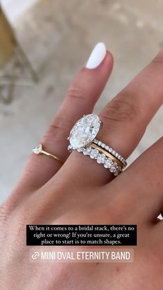 a woman's hand with two wedding rings on it and a quote about her engagement ring