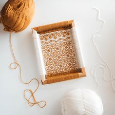 the yarn is being used to make an intricate design on this piece of wood and fabric