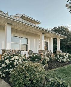 a house with white flowers in front of it