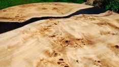 a piece of wood that has been cut in half and is laying on the ground