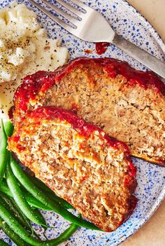 meatloaf, mashed potatoes and green beans on a blue plate with a fork