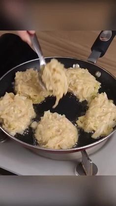 a person cooking food in a pan on the stove