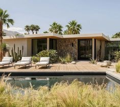 a house with a pool surrounded by palm trees