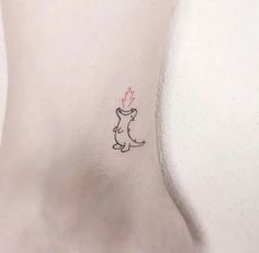 a small tattoo on the back of a woman's left side ribcage