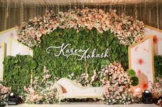 the floral backdrop is decorated with pink flowers and greenery