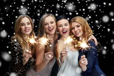 four women are holding sparklers in their hands