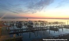 there are many docks that can be seen in the water at sunrise or sunset time