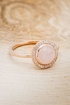 Product Details Ring Style:The "Terra" is a rose quartz women's engagement ring with a diamond halo. Many other center stone optionsareavailable upon request. Center Stone: 8mmRound Cut Rose Quartz Materials: 14K gold engagement ring featuring arose quartz center stone and 1/8 CTW diamond accents. Customizable:Because each ring is handcrafted to order, we can customize yours using unique materials, gemstones, or design features, often without any added cost! We can even use personal materials th Rose Quartz Engagement Ring, Rose Quartz Ring Engagement, Quartz Engagement Ring, Antler Ring, Staghead Designs, Rose Quartz Ring, Ring With Diamond, Montana Sapphire, Detailed Ring