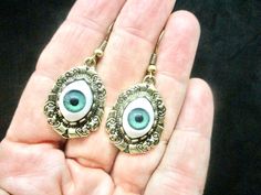 "We only have one pair.  Gothic, boho, hippie, contemporary \"Evil Eye\" dangle pierced earrings.  hallmarked 925  These pierced eyes measure 40mmX20mm.  They have an antique bronze look. Approx 1960s No condition issues. Sixth chakra, the Ajna chakra An invisible yet powerful third eye, this is your center of intuition. A spiritual chakra, which means \"beyond wisdom,\" The blue green eye portions are most likely a lucite All sales are final. No Returns or are at our discretion as per our policy for exchange or store credit only." Unique Nickel-free Jewelry For Halloween, Mystical Nickel-free Teardrop Jewelry, Mystical Teardrop Nickel-free Jewelry, Mystical Nickel-free Halloween Jewelry, Bohemian Jewelry For Halloween Gift, Bohemian Gold Jewelry For Halloween, Handmade Bohemian Earrings For Halloween, Handmade Bohemian Jewelry For Halloween, Mystical Drop Earrings For Festival