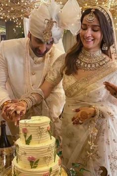 a newly married couple cutting their wedding cake