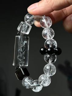 This elegant bracelet, crafted from white crystal, mica crystal, and obsidian, symbolizes the power of complete energy purification and transformation. It is designed to help you break through previously insurmountable challenges. The bracelet fits a 15cm wrist, with round beads approximately 13mm in size. Mica Crystal, Elegant Bracelet, White Crystal, Round Beads, Arm Band, Favorite Jewelry, Jewelry Bracelets, Accessory Gift, Beaded Bracelets