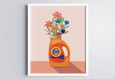 an orange jug with flowers in it sitting on a table