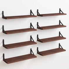 six wooden shelves with black metal brackets on them