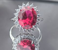 a close up of a ring with a large red stone