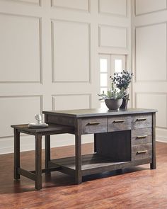 two wooden tables sitting on top of a hard wood floor next to each other in front of a white wall