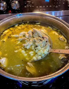 a large pot filled with soup on top of a stove next to a burner