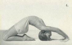 an old photo of a man laying on the ground with his hands behind his head