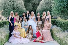 a group of women in dresses posing for a photo