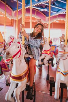 a woman sitting on top of a merry go round