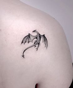 a woman with a dragon tattoo on her back