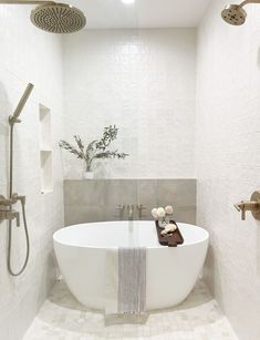 a white bath tub sitting next to a shower head