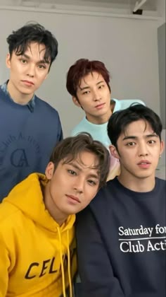 four young men standing next to each other in front of a white wall with the words saturday for club actors on it