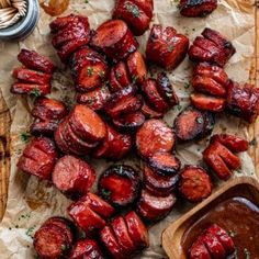 the food is prepared and ready to be eaten on the cutting board with sauces