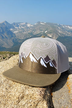 Flatbill snapback hat -- Medium Gray/Olive. Topo map screen printed on front panels. Embroidered mountains. Green snapback. Embroidered Mountains, Nanak Jayanti, Guru Nanak