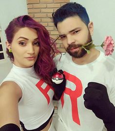 the man and woman are posing together for a photo with flowers in their hair,