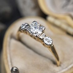 an engagement ring with three diamonds in it