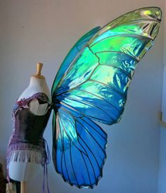 a blue butterfly sitting on top of a mannequin