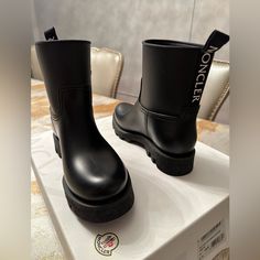 Women Moncler Black And White Boots Wore Once Pull-On Boot With A Small Platform And A Small Logo. ( No Returns ) Luxury High-top Boots With Rubber Sole, Luxury High-top Waterproof Boots With Rubber Sole, Moncler Boots Woman, Luxury Women's Mid-calf Boots With Buckle Closure, Moncler Moon Boots, Black And White Boots, Moncler Women, Pull On Boots, Rain Boots