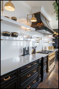 Modern kitchen with black cabinets, gold handles, and white countertops, featuring a gold stove and hood, open shelving with dishes, and brass lighting fixtures. White Black And Gold Home Decor, Black And White Gold Aesthetic, Black Cabinets White Countertops Gold Hardware, Black And Gold Kitchen Aesthetic, Gold Black White Kitchen, Gold And Black Interior Design, Black White And Gold Kitchen Modern, White Grey Gold Kitchen, Brown And Black Kitchen Ideas