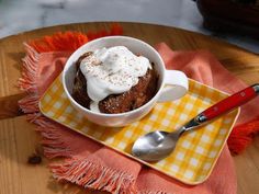 a bowl of food sitting on top of a yellow and white checkered table cloth