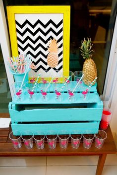 a table with cups and pineapples on it