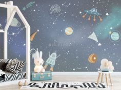 a child's room with space themed wallpaper and toys in the foreground