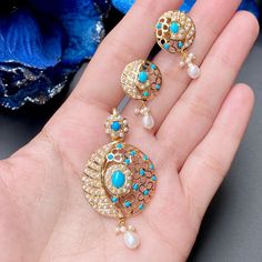 Featuring a delicate pendant set crafted in 22ct gold. It has been embellished with precious pearls and turquoises. The stellar design of this set exudes sophistication and elegance, making it an ideal accessory for any special occasion. It weighs 11.43 GMs including 0.69 GMs of hanging pearls Price Breakup Summary Component Rupees % of Total 22k Gold 56,320 78.8% Stones & Beads 2,957 4.1% Making Charges 10,138 14.2% Taxes (GST) 2,082 2.9% Total 71,497 100.0% View Detailed Price Breakup Here Elegant Turquoise Round Jewelry Sets, Elegant 22k Gold Blue Jewelry, Elegant Turquoise Jewelry Sets For Wedding, Elegant Turquoise Wedding Jewelry Sets, Turquoise Pendant Jewelry For Wedding, Turquoise Fusion Jewelry For Wedding, Turquoise Gold Plated Jewelry With Matching Earrings, 22k Gold Jewelry Necklaces, Delicate Pendant