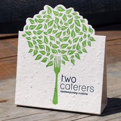 a white card with a green tree on it that says two caterhers eco cooking challenge