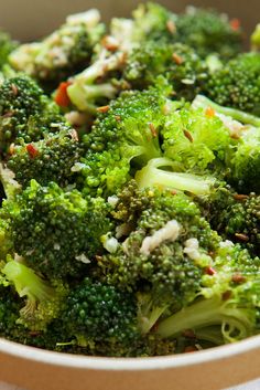 a bowl filled with broccoli on top of a table