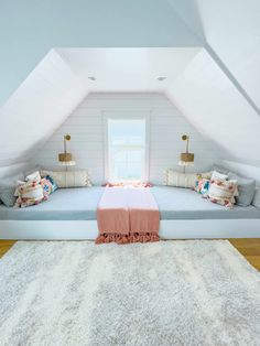 a bed sitting in the middle of a bedroom next to a white rug on top of a hard wood floor