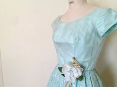 "super pretty dress from the 1950s. pastel blue-green / green-blue a la Robin's Egg (with a hint of mint). scoop neckline. sheer organza overlay on bodice with darts down the front and short cap sleeves. fitted waist. skirt is puffy with a tulle underneath and an amazing organza overlay, with cut out tulip pattern. large cabbage rose embellishment with ribbons and rosebuds. metal zipper down the back. at 5'8\", the dress falls just below the knee. peach taffeta with tiers and tiers of floral lac Organza Overlay, Dress Organza, 1990s Dress, Tulle Underskirt, Tulip Pattern, Blue Party Dress, Robin's Egg Blue, Cabbage Rose, Fabric Roses