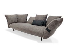 a gray couch with black pillows on it