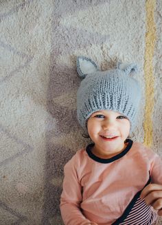 Our sweet bunny hat is perfect for new spring babes. These have a nice fit around the base of the hat that keeps it from getting stretched out. The color in the ears is such a simple but cozy detail. Bailey Bunny comes in three different colors: choose between White with Gray ears, White with Pink ears or Gray with White ears. Any color you decide will have you ﻿hopping﻿ with joy. Photo by: @andrea.coonrod Cute Knitted Cat Ears Hat, Cute Cat Ears Hat, Playful Warm Bonnet Cap, Warm Cute Bonnet, One Size Fits Most, Cute Warm Cat Ears Hat, Cute One Size Beanie, Cute One Size Fits Most Beanie, Warm Cat Ears Hat One Size Fits Most, Warm Cat Ears Hat, One Size Fits Most