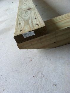 a piece of wood sitting on top of a white floor next to a wooden bench