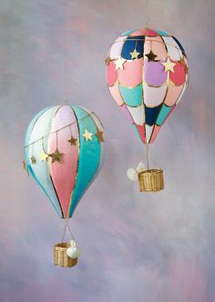 two colorful hot air balloons with stars on them