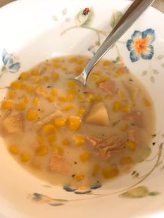 a white bowl filled with corn and meat soup