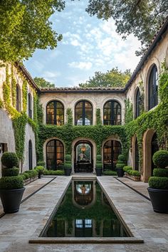 Courtyard with lush ivy and reflection pool. Embark on a whirlwind tour of luxurious abodes where opulence meets whimsy, leaving you green with envy and ideas for your next home upgrade.