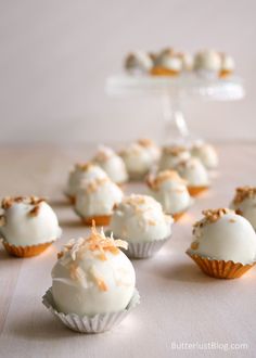 small cupcakes with white frosting and orange sprinkles on top